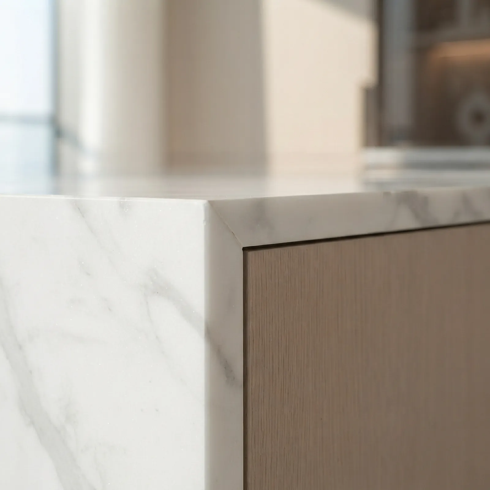 Marble waterfall edge meeting oak cabinetry