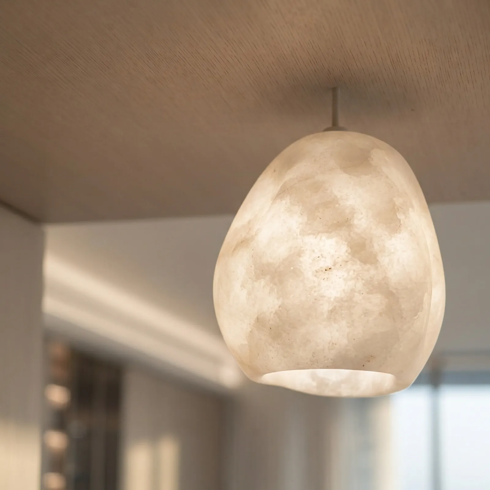 Alabaster pendant against an oak ceiling
