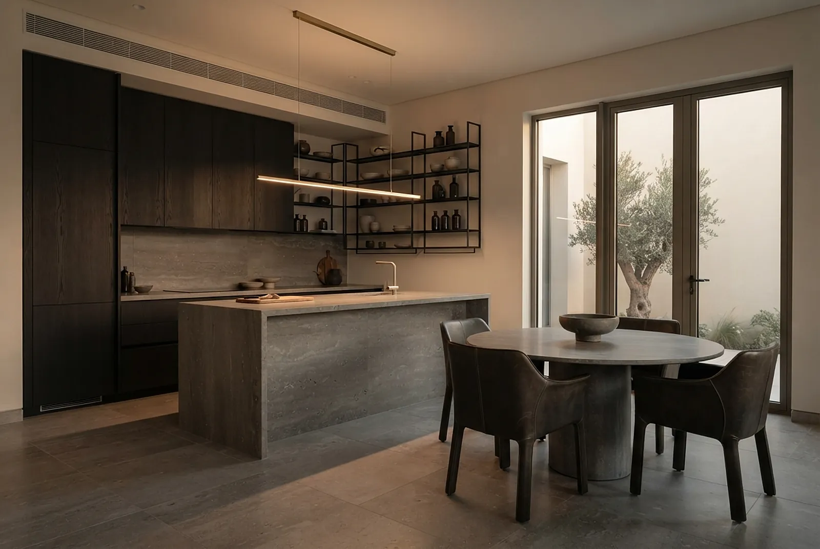 Dark kitchen with travertine island and courtyard view