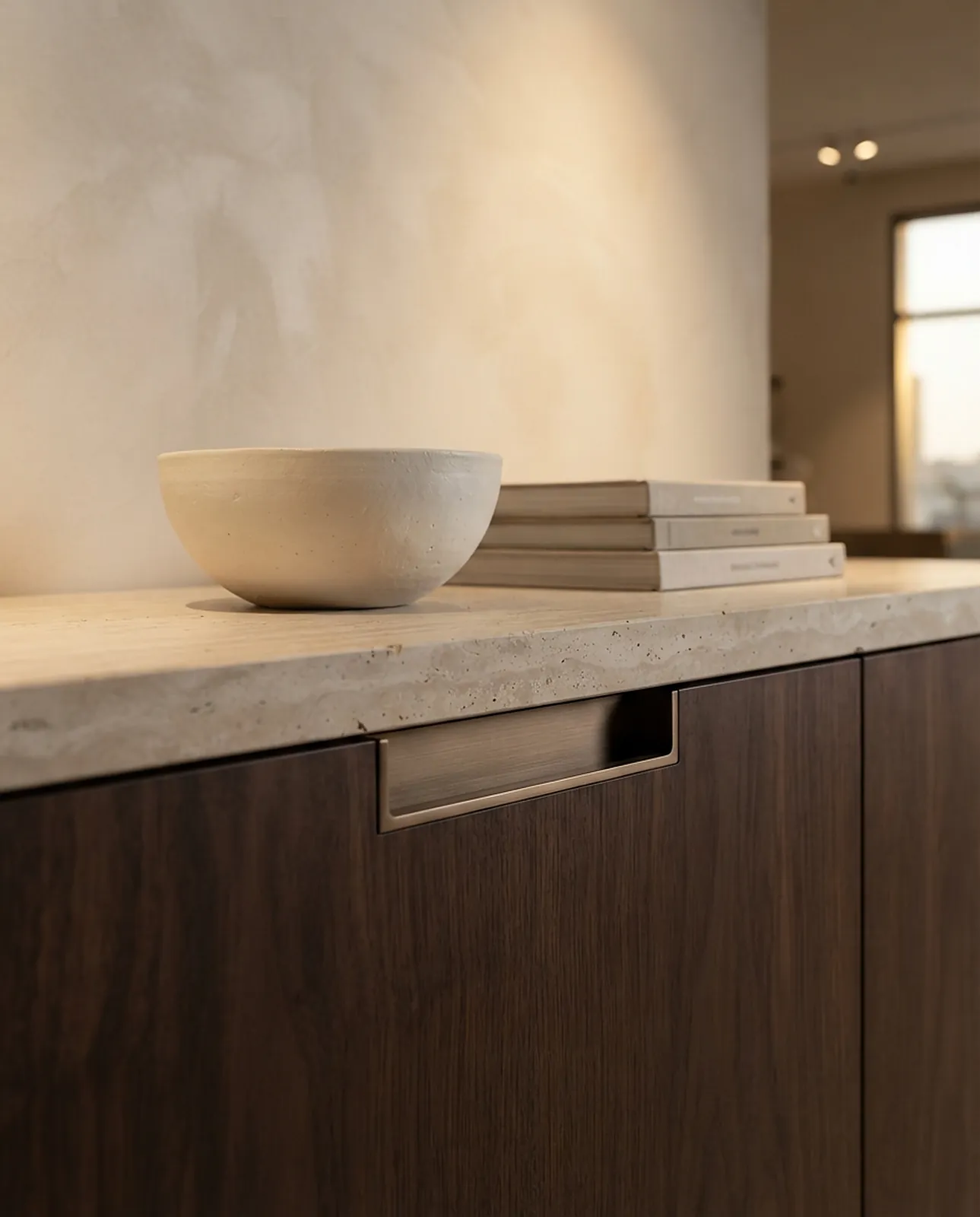 Walnut cabinet with a travertine top and ceramic bowl